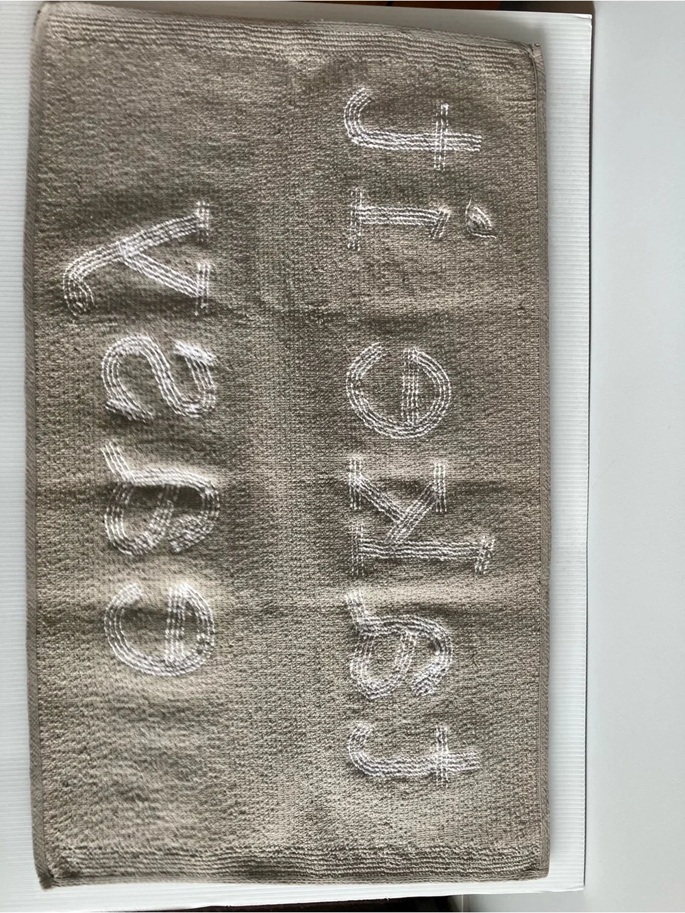 Taupe Bath Rug with White Raised 'take it easy' Text